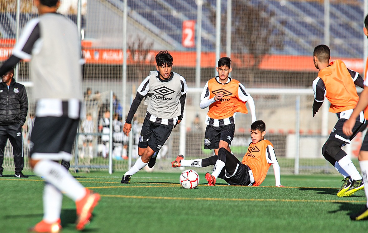 Young football players training at golden hour